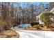 Private backyard boasts a swimming pool, mature landscaping, and ample space for outdoor enjoyment at 105 Leisure Trl, Peachtree City, GA 30269