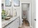 Bathroom features double sink vanity with granite countertop, decorative mirrors, and open toilet room at 105 Leisure Trl, Peachtree City, GA 30269
