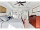 Bedroom showcasing a large window, tray ceilings, and classic furniture, designed for comfort at 105 Leisure Trl, Peachtree City, GA 30269