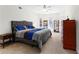 Bright primary bedroom features plush carpet, neutral paint, and large windows overlooking a manicured lawn at 105 Leisure Trl, Peachtree City, GA 30269