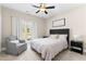 Bedroom features a full-size bed, comfortable armchair, bedside tables, and large sunlit windows at 105 Leisure Trl, Peachtree City, GA 30269