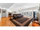 Bright living room features hardwood floors, oversized rug, and a wall of windows overlooking the backyard pool at 105 Leisure Trl, Peachtree City, GA 30269