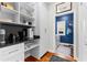 Walk-in pantry with custom shelving, a countertop, and views of the laundry room at 105 Leisure Trl, Peachtree City, GA 30269