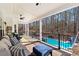 Inviting covered patio with comfortable seating, ceiling fan, and a view of the gorgeous swimming pool at 105 Leisure Trl, Peachtree City, GA 30269