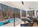 Relaxing covered patio features ceiling fans, comfortable seating, and a view of the inviting backyard pool at 105 Leisure Trl, Peachtree City, GA 30269