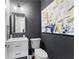 Stylish powder room with dark gray walls, modern vanity, and elegant decorative accents at 105 Leisure Trl, Peachtree City, GA 30269