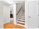 Staircase with hardwood steps, white risers, and a wooden handrail leading to the second level of the home at 105 Leisure Trl, Peachtree City, GA 30269