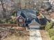 An aerial view of the two-story brick and siding home featuring an attached garage and manicured lawn at 1098 Berkley Se Dr, Smyrna, GA 30082