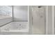 Bright bathroom with jacuzzi tub, and glass shower at 1098 Berkley Se Dr, Smyrna, GA 30082