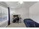 A simple bedroom featuring a single bed, gaming computer, and a window with natural light at 1098 Berkley Se Dr, Smyrna, GA 30082