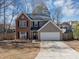 Charming two-story home featuring a brick facade, attached garage, and well-maintained landscaping at 1098 Berkley Se Dr, Smyrna, GA 30082