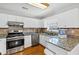 Well-equipped kitchen with stainless steel appliances, granite countertops, and white cabinetry at 1098 Berkley Se Dr, Smyrna, GA 30082