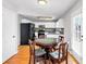 Bright eat-in kitchen features white cabinetry, stainless appliances, and hardwood floors at 1098 Berkley Se Dr, Smyrna, GA 30082