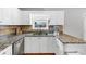 Close up on stainless steel appliances and granite counters in a brightly lit kitchen with white cabinetry at 1098 Berkley Se Dr, Smyrna, GA 30082