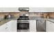Close up on stainless steel appliances and granite counters in a brightly lit kitchen with white cabinetry at 1098 Berkley Se Dr, Smyrna, GA 30082