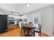 Sunlit eat-in kitchen with stainless appliances, white cabinets, tile backsplash and hardwood floors at 1098 Berkley Se Dr, Smyrna, GA 30082