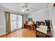 Inviting living room with hardwood floors, a ceiling fan, and large windows offering natural light at 1098 Berkley Se Dr, Smyrna, GA 30082