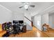 Inviting living room with hardwood floors, a ceiling fan, and large windows offering natural light at 1098 Berkley Se Dr, Smyrna, GA 30082