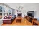 Inviting living room featuring a brick fireplace, hardwood floors, and natural light from large windows at 1098 Berkley Se Dr, Smyrna, GA 30082