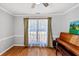 Inviting living room with hardwood floors, a ceiling fan, and large windows offering natural light at 1098 Berkley Se Dr, Smyrna, GA 30082