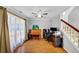 Inviting living room with hardwood floors, a ceiling fan, and large windows offering natural light at 1098 Berkley Se Dr, Smyrna, GA 30082