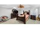 Well-lit main bedroom with ceiling fan, bed, and large dresser set at 1098 Berkley Se Dr, Smyrna, GA 30082