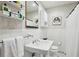 Bathroom featuring white subway tile, a pedestal sink, and framed wall art at 278 Midvale Ne Dr, Atlanta, GA 30342