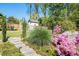 A lush green backyard with flowers, privacy fence, storage shed, and playground at 2922 Parkridge Ne Dr, Brookhaven, GA 30319