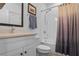 Cozy bathroom with neutral vanity, shower over tub with tile surround, and curtain at 2922 Parkridge Ne Dr, Brookhaven, GA 30319