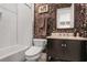 Stylish bathroom featuring a tub, decorative wallpaper, a dark vanity, and modern fixtures at 2922 Parkridge Ne Dr, Brookhaven, GA 30319