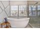 Modern bathroom showcasing a freestanding tub, geometric wall design, and natural light, for a spa-like experience at 2922 Parkridge Ne Dr, Brookhaven, GA 30319