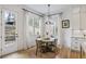 Bright dining area with hardwood floors, stylish light fixture, and adjacent door leading to outdoor stairs at 2922 Parkridge Ne Dr, Brookhaven, GA 30319