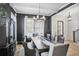Elegant dining room with a dark accent wall, chandelier, and a long wooden dining table at 2922 Parkridge Ne Dr, Brookhaven, GA 30319