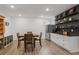 Finished basement dining room with luxury vinyl plank floors, a wet bar, and modern decor at 2922 Parkridge Ne Dr, Brookhaven, GA 30319