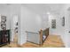 Bright hallway with hardwood floors, iron railing, and decorative artwork at 2922 Parkridge Ne Dr, Brookhaven, GA 30319