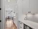 Modern kitchen features white cabinets, quartz countertops, stainless steel appliances, and subway tile backsplash at 2922 Parkridge Ne Dr, Brookhaven, GA 30319
