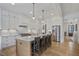 Modern kitchen with white cabinets, a large island with seating, and stainless steel appliances at 2922 Parkridge Ne Dr, Brookhaven, GA 30319