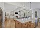 Open floor plan with hardwood floors, a kitchen island, fireplace, and built-in shelving in living area at 2922 Parkridge Ne Dr, Brookhaven, GA 30319