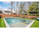 Relaxing pool with a spa, lounge chairs, umbrellas, and artificial turf at 2922 Parkridge Ne Dr, Brookhaven, GA 30319