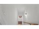 Bright stairwell with hardwood floors, a light fixture, and white walls at 2922 Parkridge Ne Dr, Brookhaven, GA 30319