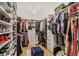Spacious walk-in closet with custom shelving, hanging racks, and a stylish ottoman for organization and convenience at 2922 Parkridge Ne Dr, Brookhaven, GA 30319
