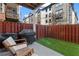 Backyard patio with artificial turf, a chair set, and a grill makes a great outdoor living space at 1029 Emory Parc Pl, Decatur, GA 30033