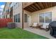 Backyard patio with artificial turf, two chairs, and a grill makes a great outdoor living space at 1029 Emory Parc Pl, Decatur, GA 30033