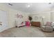 A bright bedroom features a round patterned rug, a modern dresser, and a white crib with flower decals at 1029 Emory Parc Pl, Decatur, GA 30033