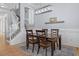 Light-filled dining area with a wooden table and staircase with neutral decor at 1029 Emory Parc Pl, Decatur, GA 30033