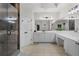 Well-lit main bathroom with a shower, soaking tub, and spacious white vanity with dark hardware at 1029 Emory Parc Pl, Decatur, GA 30033