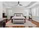 This main bedroom features a tray ceiling, plantation shutters, and polished wood flooring at 1029 Emory Parc Pl, Decatur, GA 30033