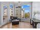 Bright sitting area with views of the exterior with hardwood floors and a comfortable leather chair at 1029 Emory Parc Pl, Decatur, GA 30033