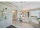 Bright bathroom showcasing marble floors, walk-in glass shower, soaking tub, and dual sink vanity at 1907 Haven Park Se Cir, Smyrna, GA 30080