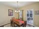 Cozy dining room area showcasing classic chandelier and table with view to an outdoor seating area at 1907 Haven Park Se Cir, Smyrna, GA 30080